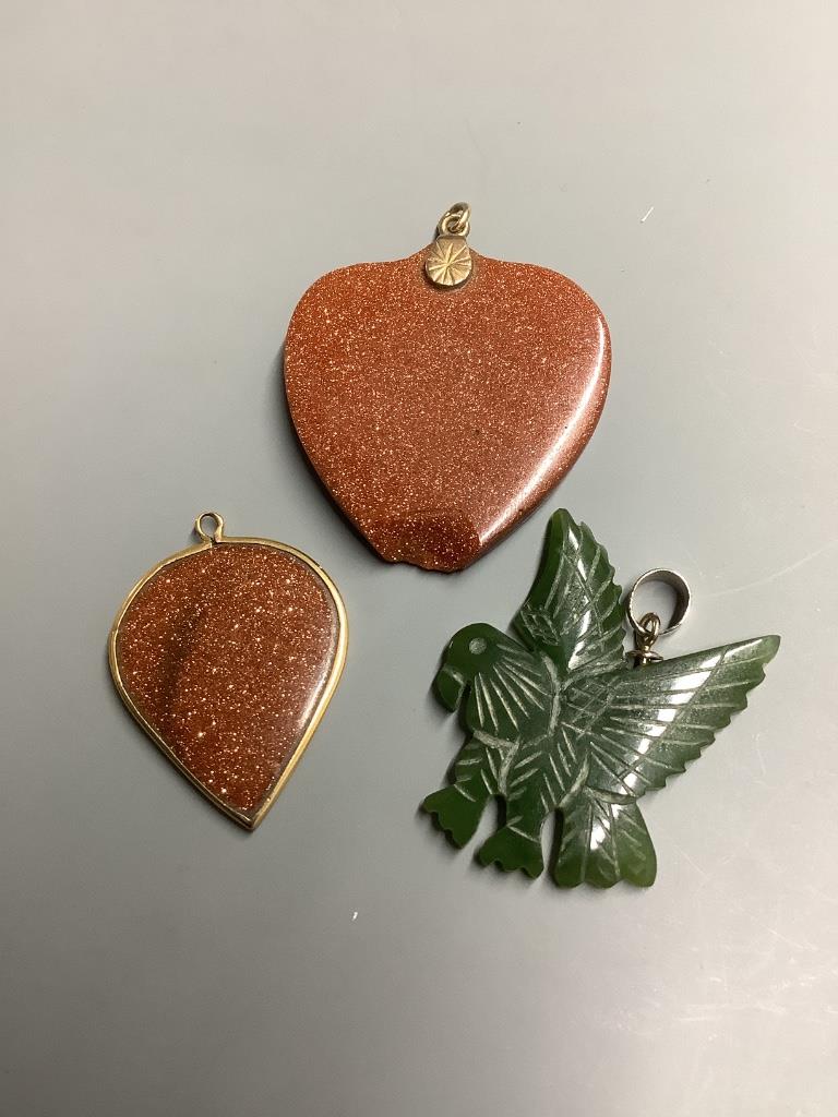 Two adventurine glass pendants, one a.f. and one other carved hardstone pendant.